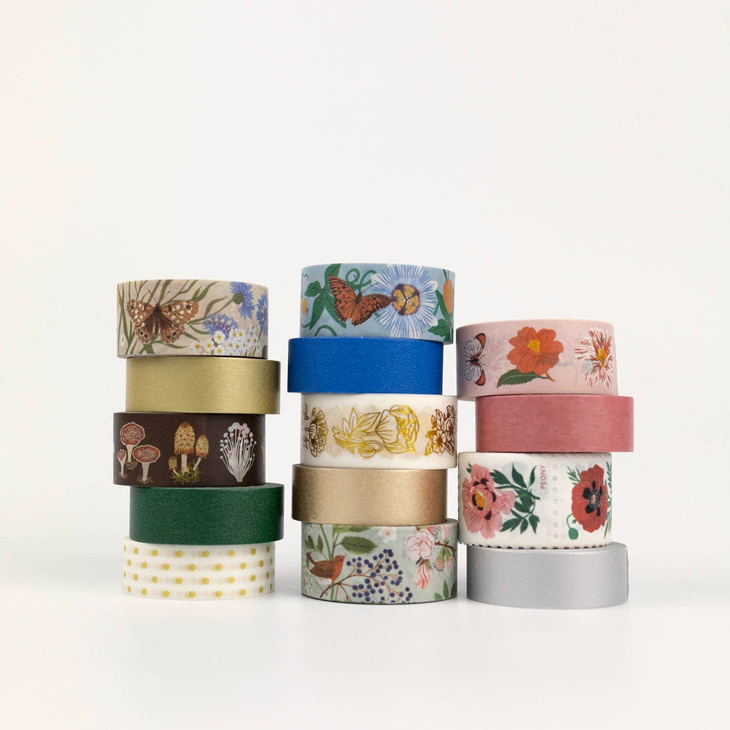 Set of colorful washi tape rolls with various designs on a white background
