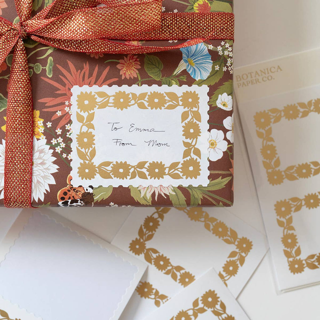 Gift wrapped with floral pattern and ribbon, featuring a personalized card.