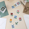 Floral stamps on a table with envelopes and scissors