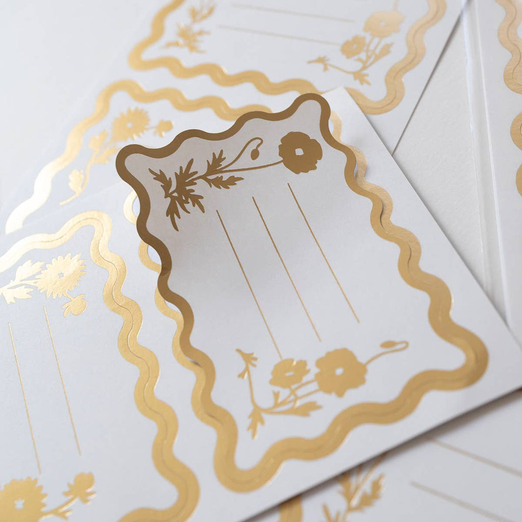 Decorative card with gold floral design on a white background