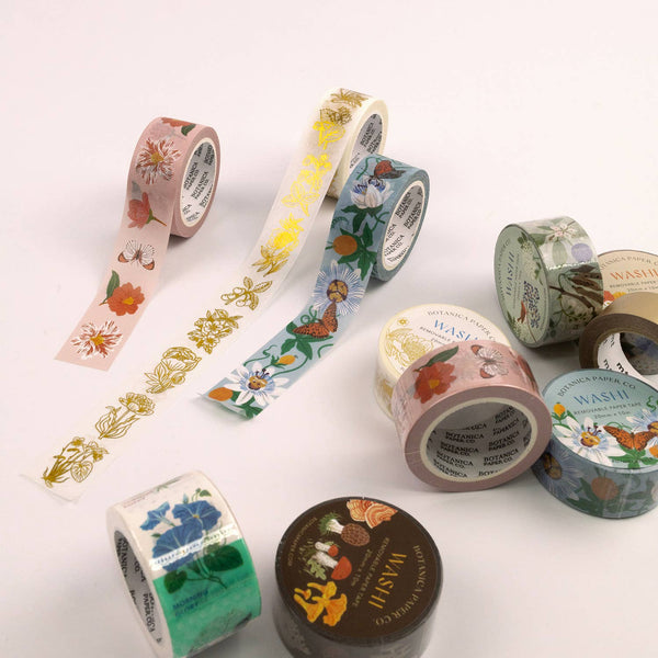 Set of decorative washi tape rolls with floral and nature-themed designs on a white background.