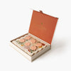 Open box of floral soap bars with 'Botanica' branding on a white background