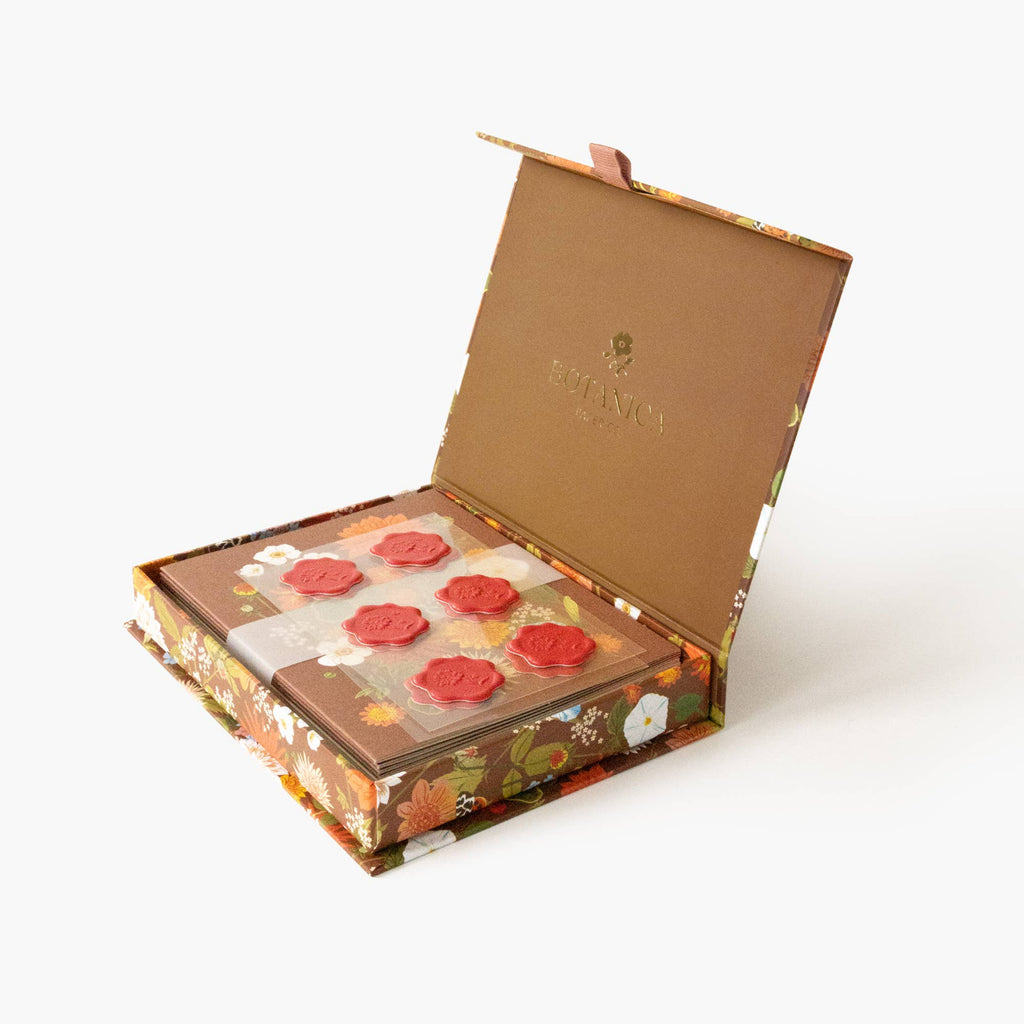 Decorative box with red floral elements on a white background