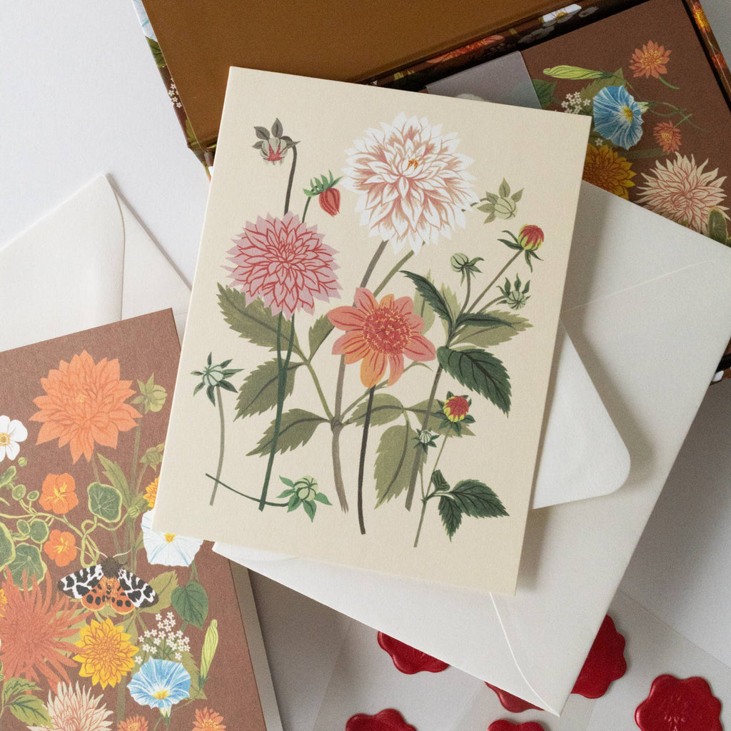 Floral card with matching envelopes on a white surface