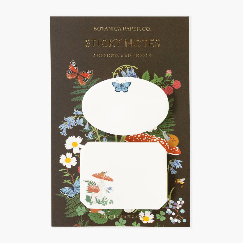 Botanica Paper Co. sticky notes with floral and butterfly design on a brown background