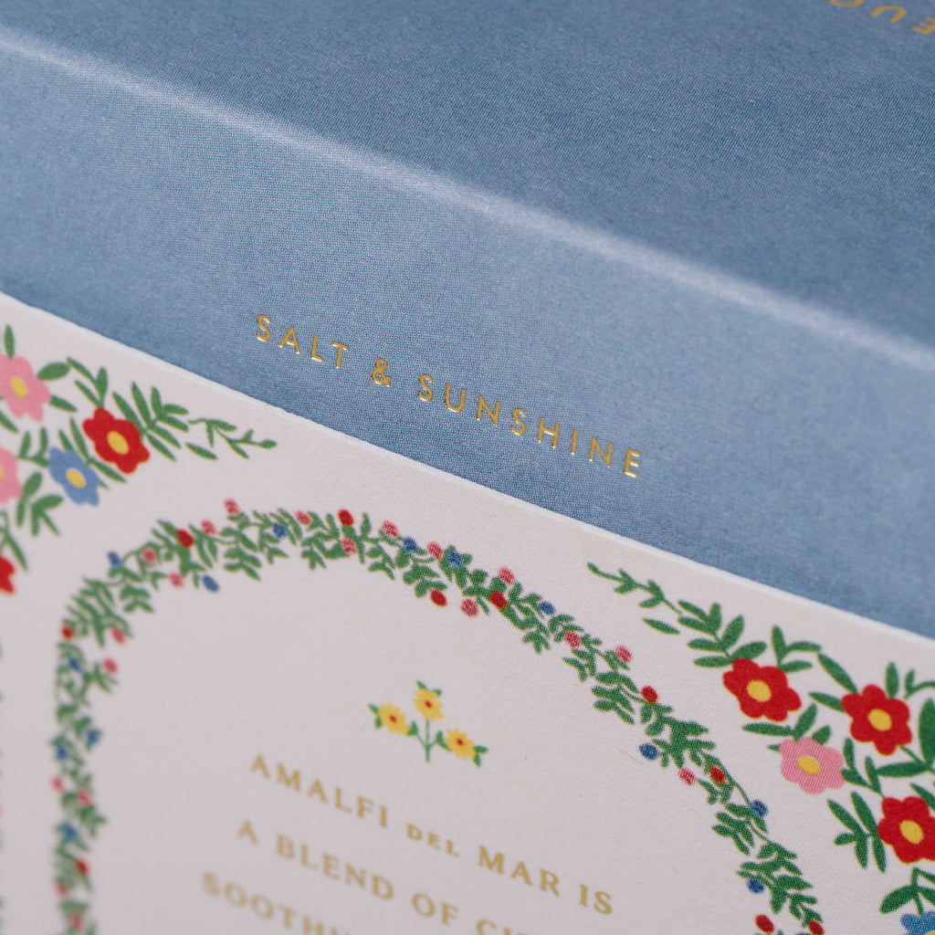 Product packaging with 'Salt & Sunshine' branding and floral design on a blue background