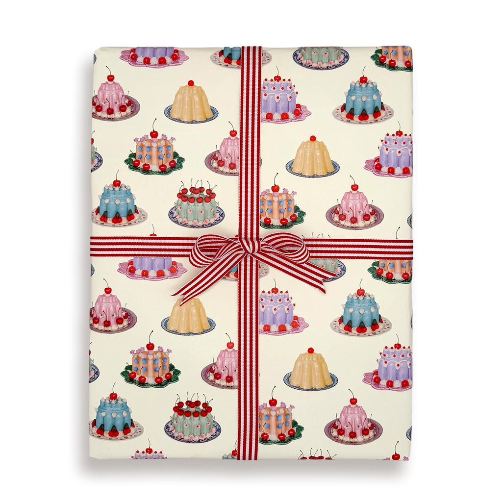 Gift wrap with cake pattern and red ribbon on a white background