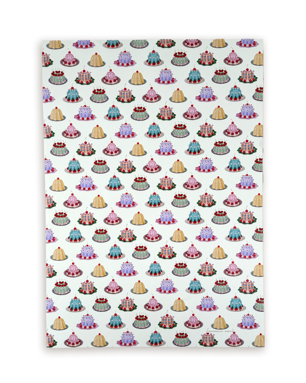 Patterned paper with small cake illustrations on a white background