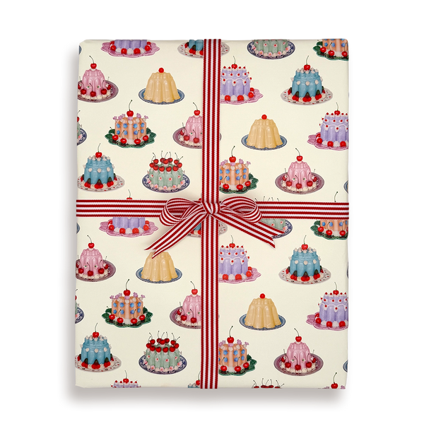 Gift wrap with cake pattern and red ribbon on a white background