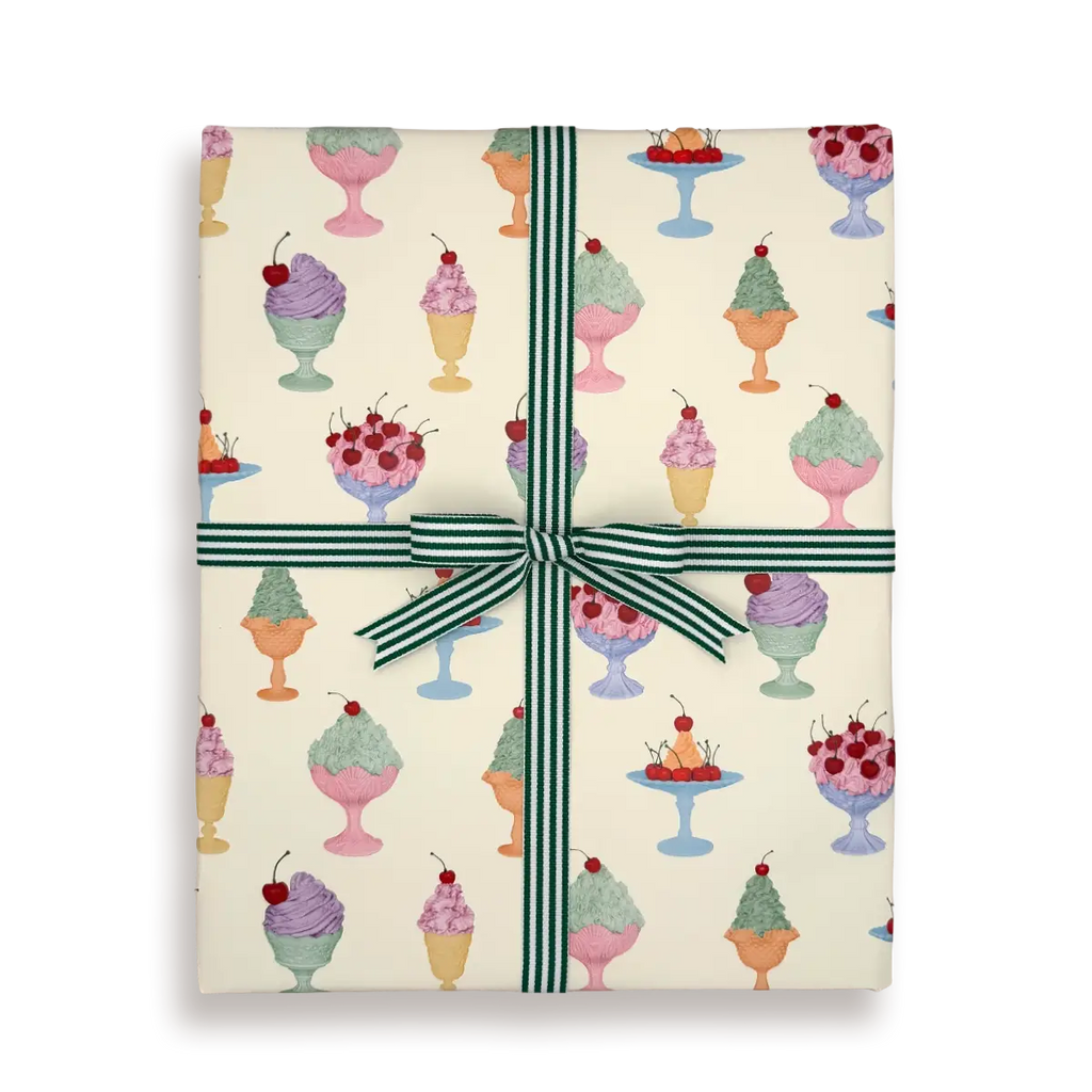 Gift box with ice cream pattern and green ribbon on a white background