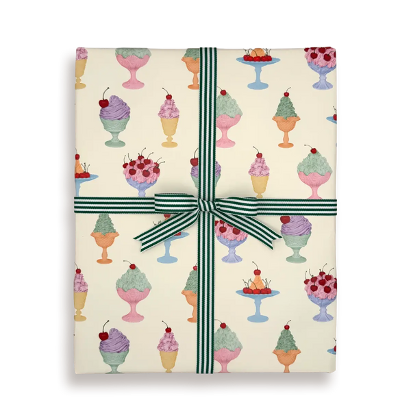 Gift box with ice cream pattern and green ribbon on a white background