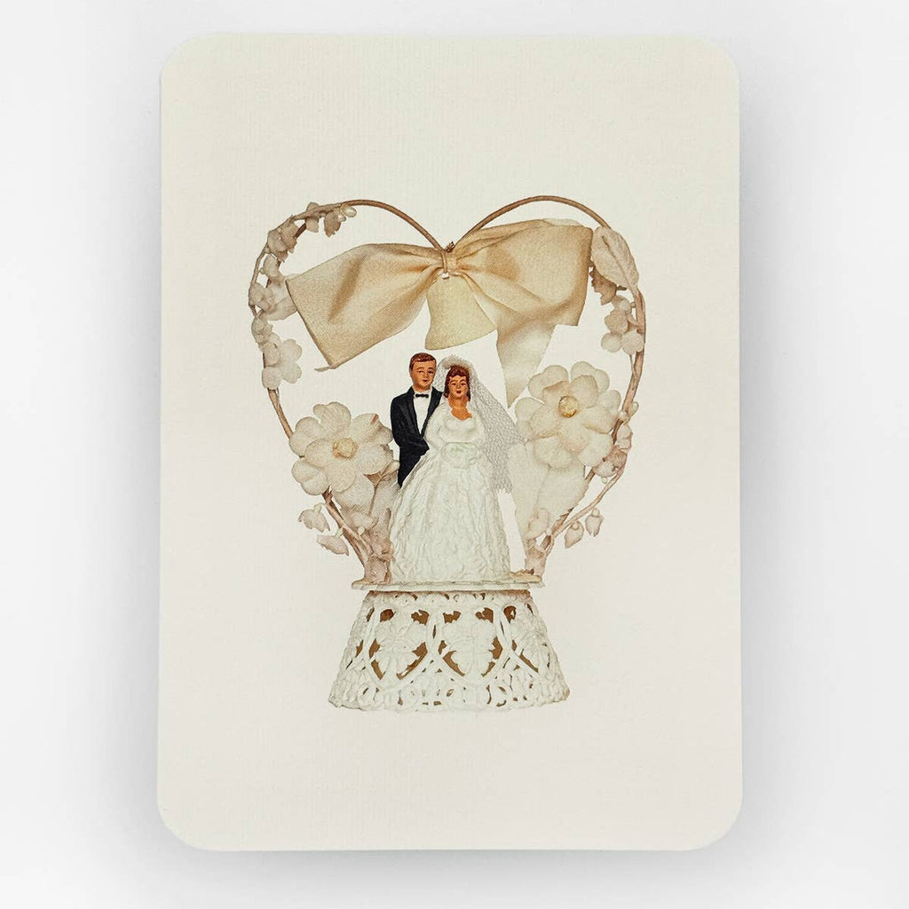 Decorative card with a heart-shaped frame, bow, and floral elements on a white background