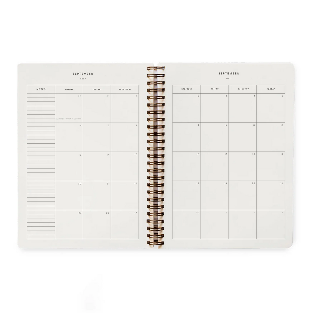 An open spiral-bound planner showing a September calendar layout with a weekly notes section on the left and a weekly grid on the right, photographed on a clean white background.