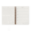 An open spiral-bound planner or agenda showing two white interior pages with lined notes, checkboxes, and weekly planning sections, photographed on a clean white background.