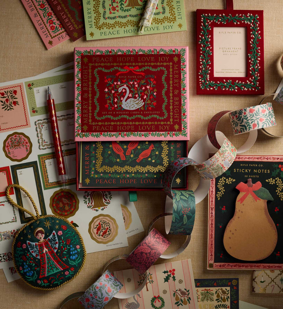 Collection of Christmas-themed stationery items on a wooden surface