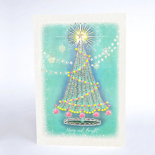 Christmas card with a decorated tree on a light blue background
