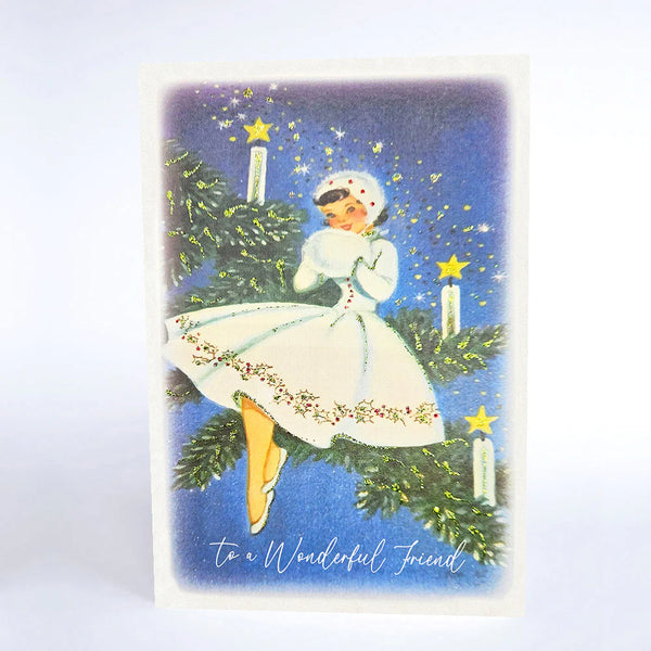 Vintage-style Christmas card with a woman in a white dress sitting on a Christmas tree, surrounded by stars and candles.