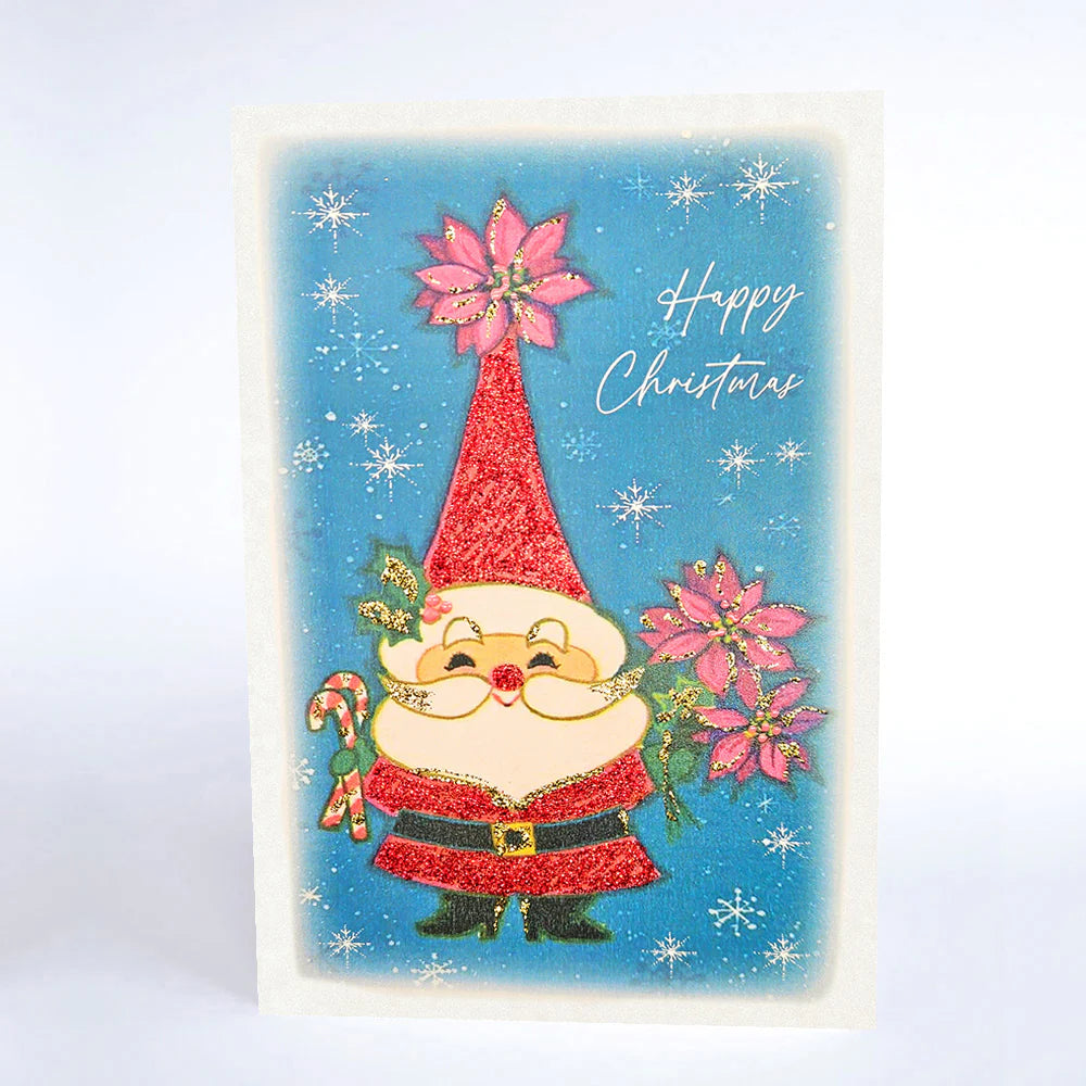Vintage-style Christmas card with a gnome holding poinsettias and candy canes on a blue background with snowflakes.