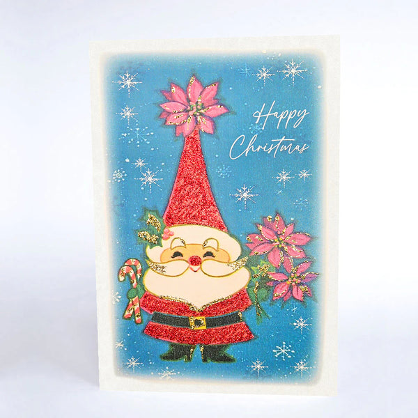 Vintage-style Christmas card with a gnome holding poinsettias and candy canes on a blue background with snowflakes.