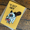Greeting card with a cat illustration and 'The Best Mum' text on a wooden surface