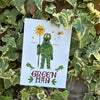 Card with a illustration of a 'Green Man' surrounded by leaves on a leafy background