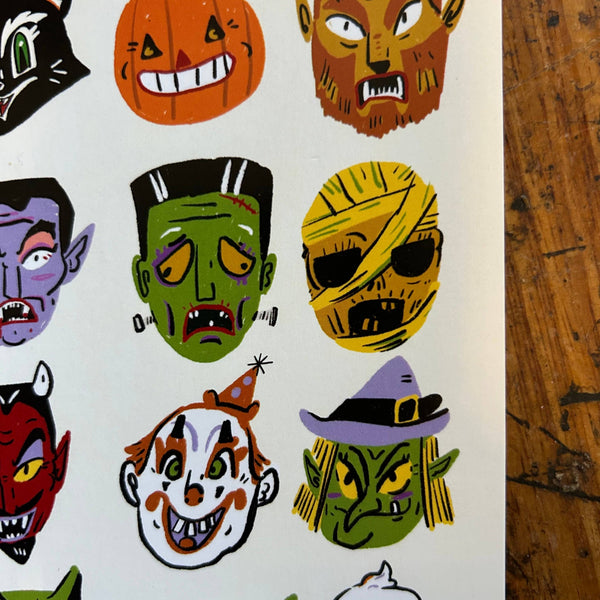 Set of colorful Halloween-themed masks on a white background