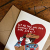 Card with cowboy illustration and heart-shaped message on a wooden surface
