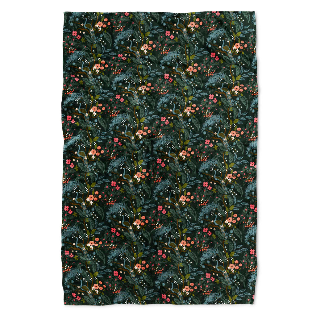 Floral patterned fabric with green leaves and pink flowers on a dark background