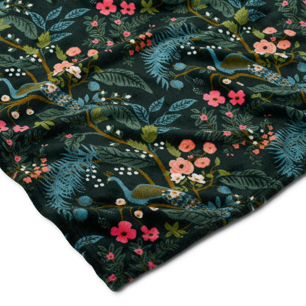Floral and dragon patterned fabric on a dark background