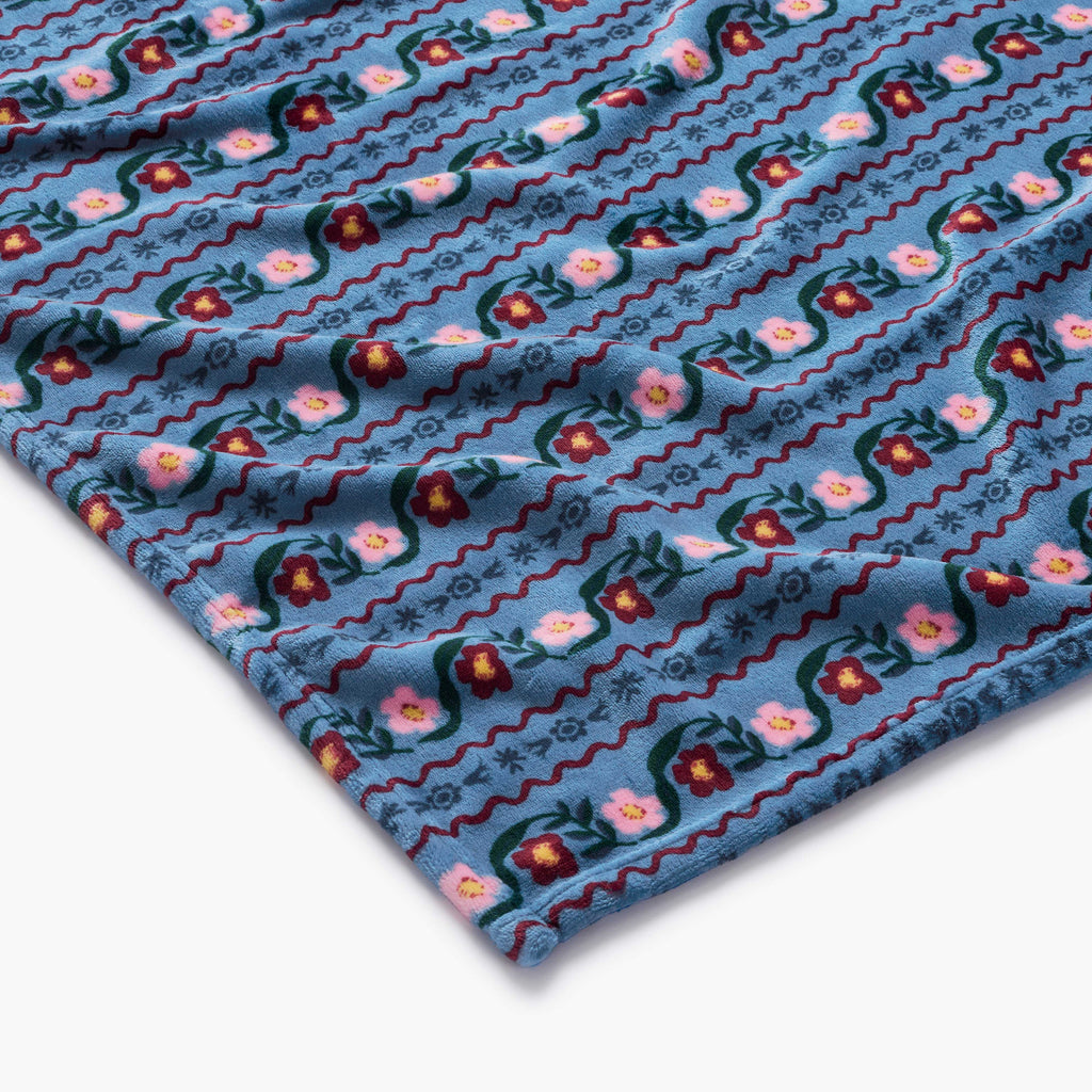 Close-up of a blue fabric with floral pattern on a white background