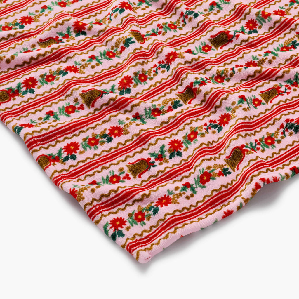 Fabric with red and white striped pattern featuring flowers and gingerbread men on a pink background