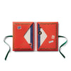 Open red book with decorative elements on a white background