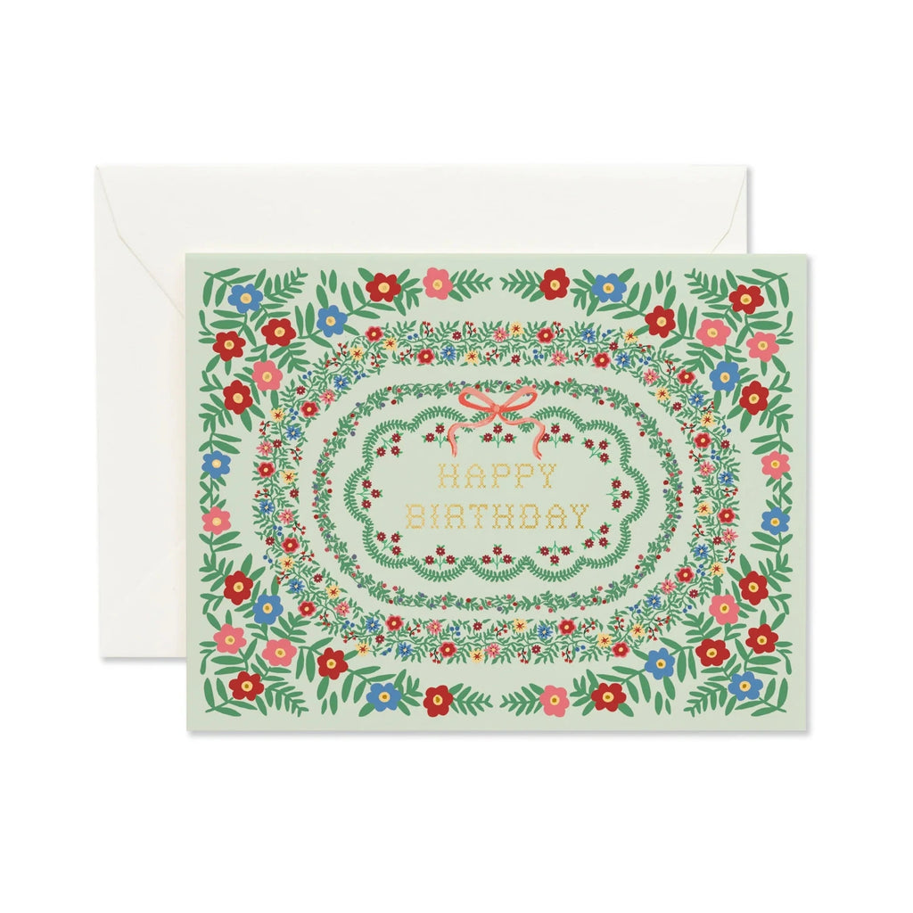 Greeting card with floral design and 'Happy Birthday' text, featuring a matching envelope.