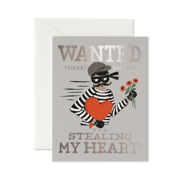 Greeting card with a design of a person in a striped outfit holding flowers and a heart, with text 'WANTED: Heart Thieves for Stealing My Heart' on a gray background.