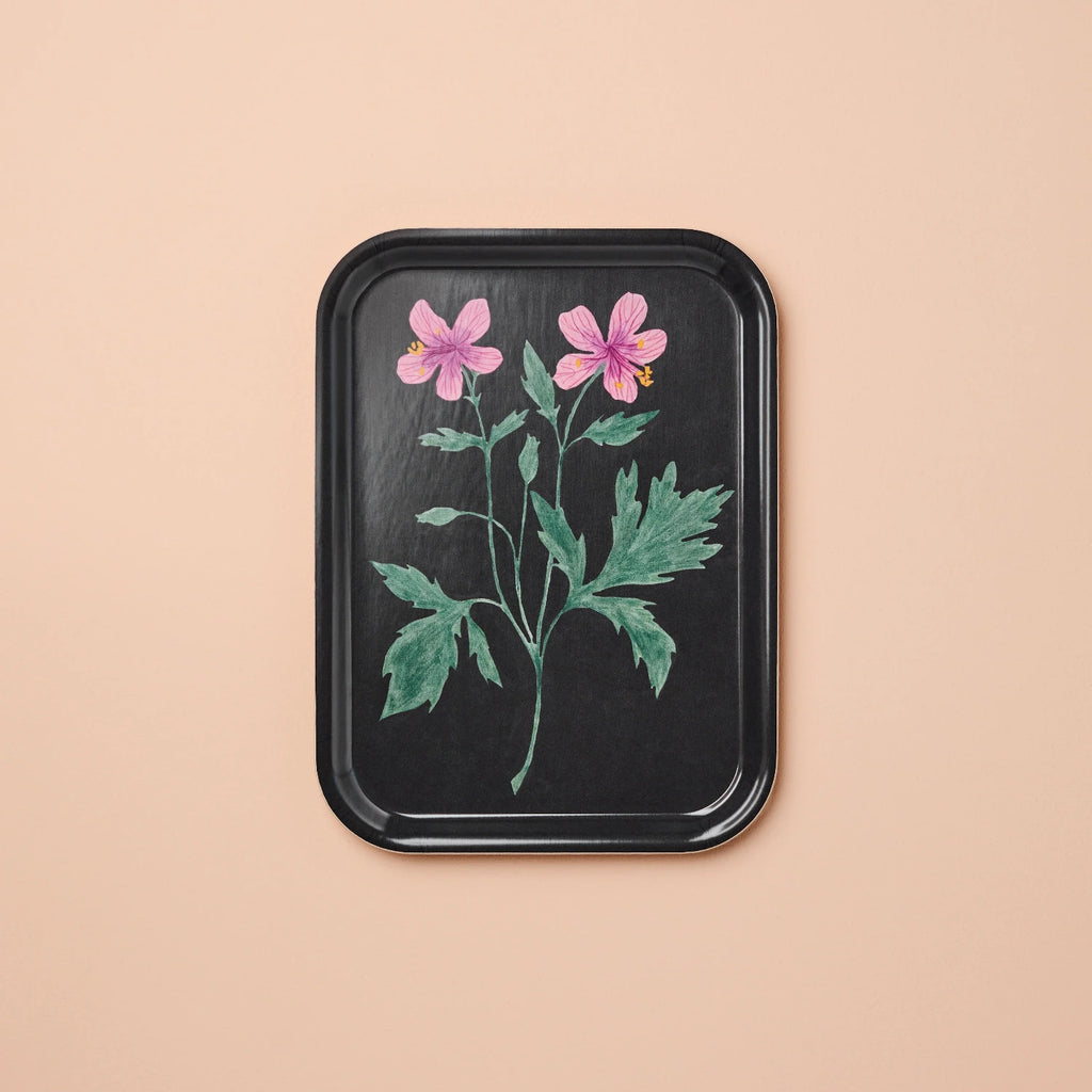 Black tray with floral design on a beige background