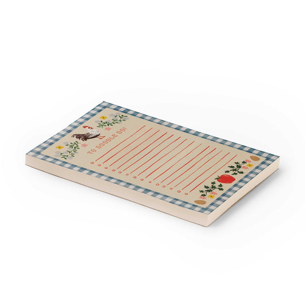 Notepad with checkered border and decorative elements on a white background