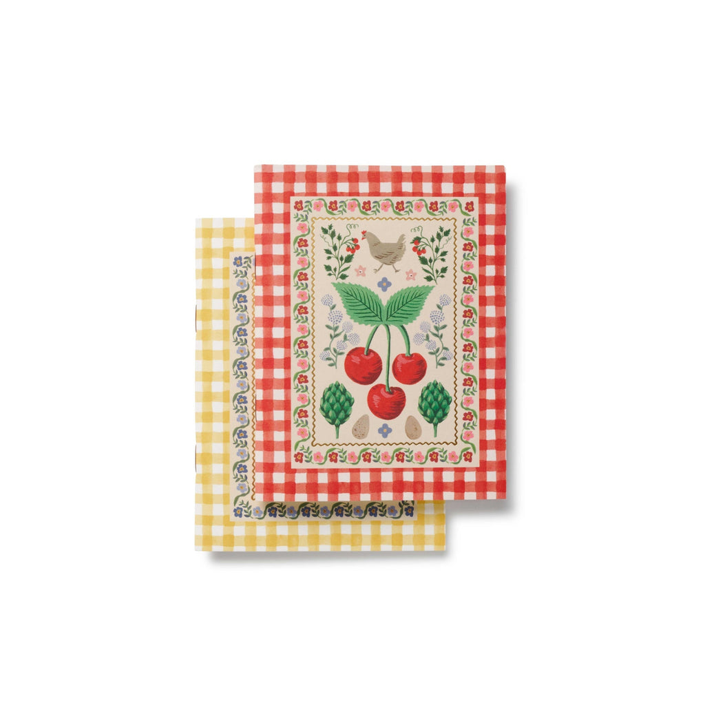 Two decorative napkins with gingham patterns and embroidered designs on a white background