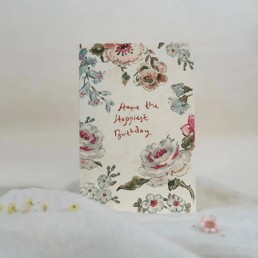 Floral birthday card with text on a white surface