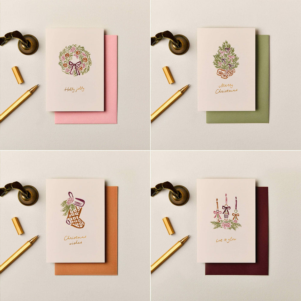 Ink & Bloom Merry Christmas card with gold foil tree illustration, buckram-textured cardstock, and soft green envelope.