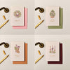 Ink & Bloom Merry Christmas card with gold foil tree illustration, buckram-textured cardstock, and soft green envelope.