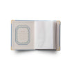 Open notebook with decorative cover on a white background