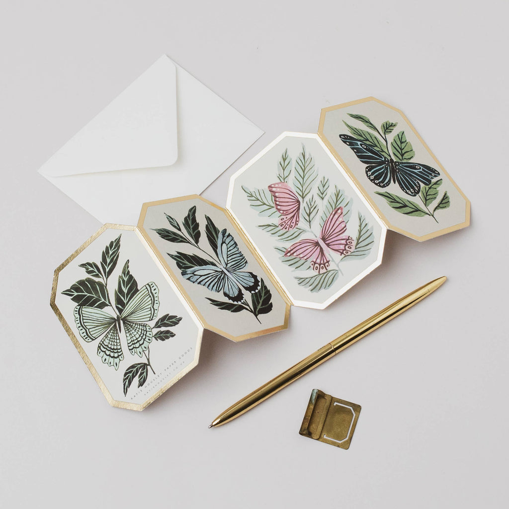 Hexagonal ceramic plates with botanical designs on a light gray background