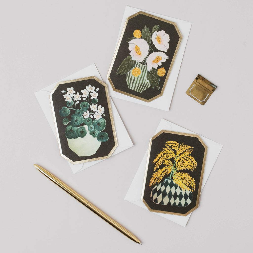 Three floral cards with green borders on a light gray background