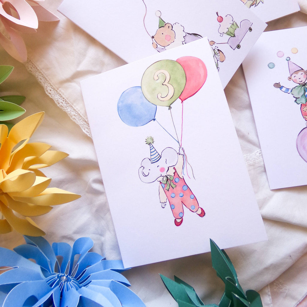 Children's birthday cards with balloons and numbers on a soft fabric background