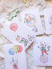 Set of birthday cards with cartoon monkey characters and balloons on a soft surface.