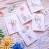 Set of children's cards with animal illustrations on a striped fabric background