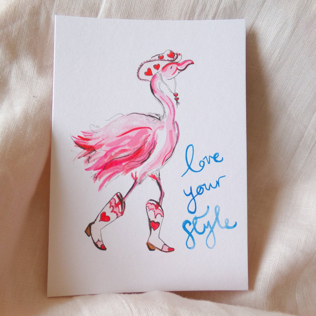 Card with a pink flamingo illustration and 'love your style' text on a soft fabric background