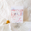 Get well soon card with a cat illustration on a white textured surface