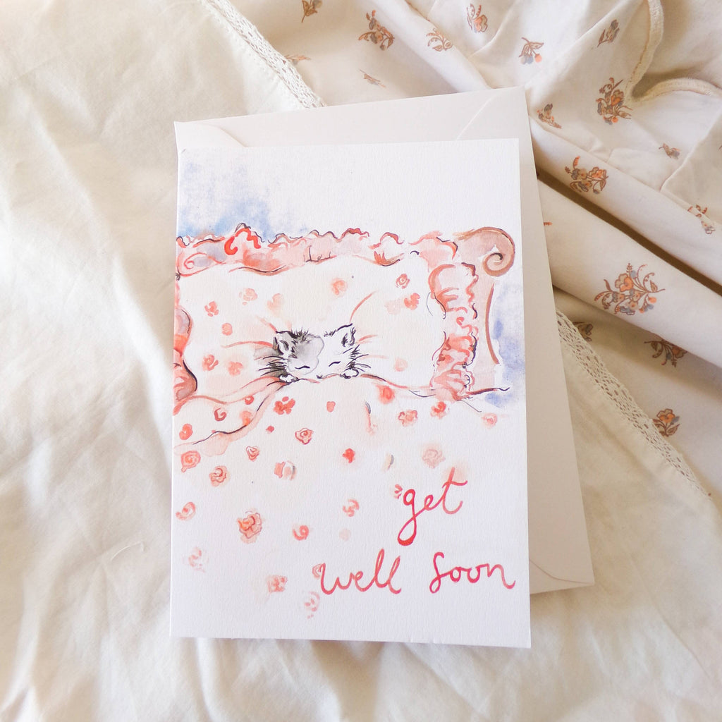 Get well soon card with a cat illustration on a soft fabric background