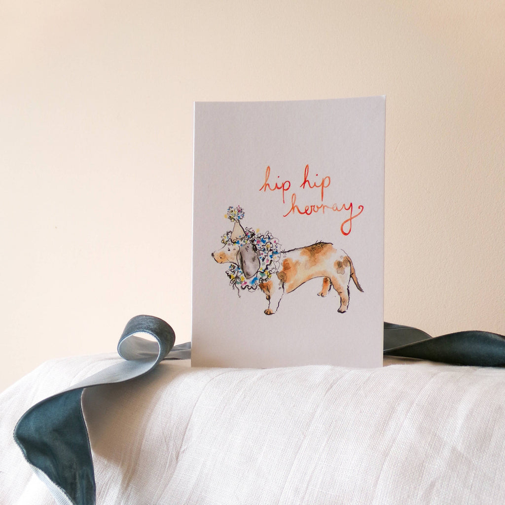 Greeting card with a dog illustration and text on a white surface